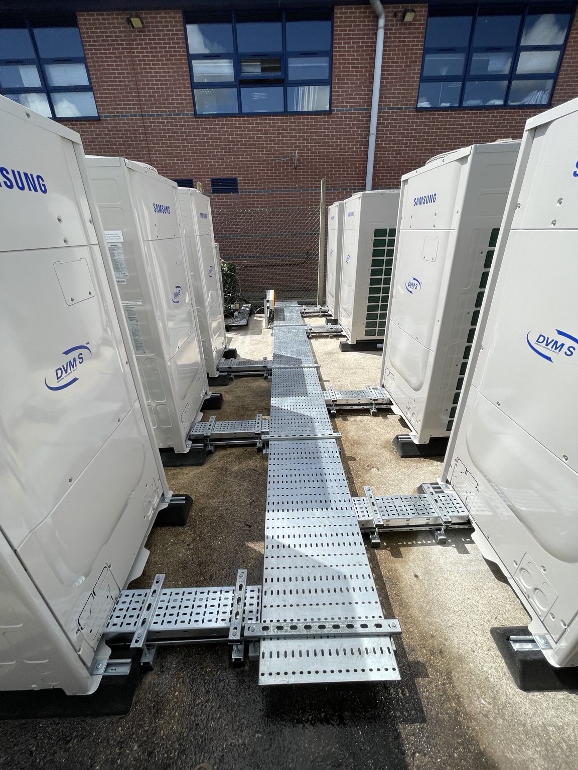Large Samsung commercial VRF outdoor units installed in a plant compound