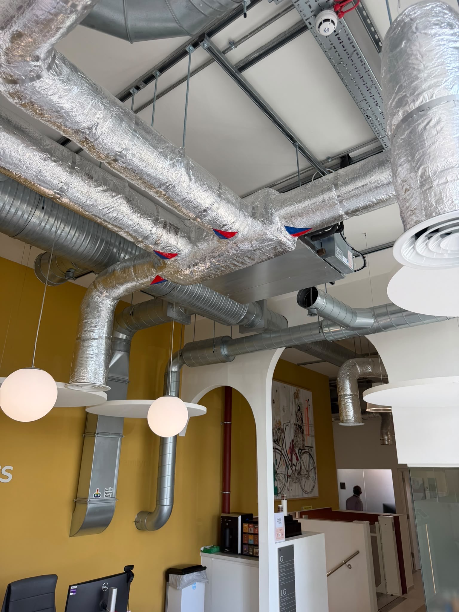 Ducted Mitsubishi air-conditioning units coordinated among exposed ceiling services