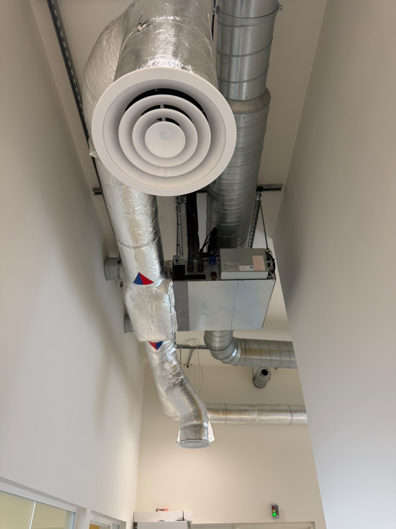 Mitsubishi ducted indoor air-conditioning unit installed above a corridor