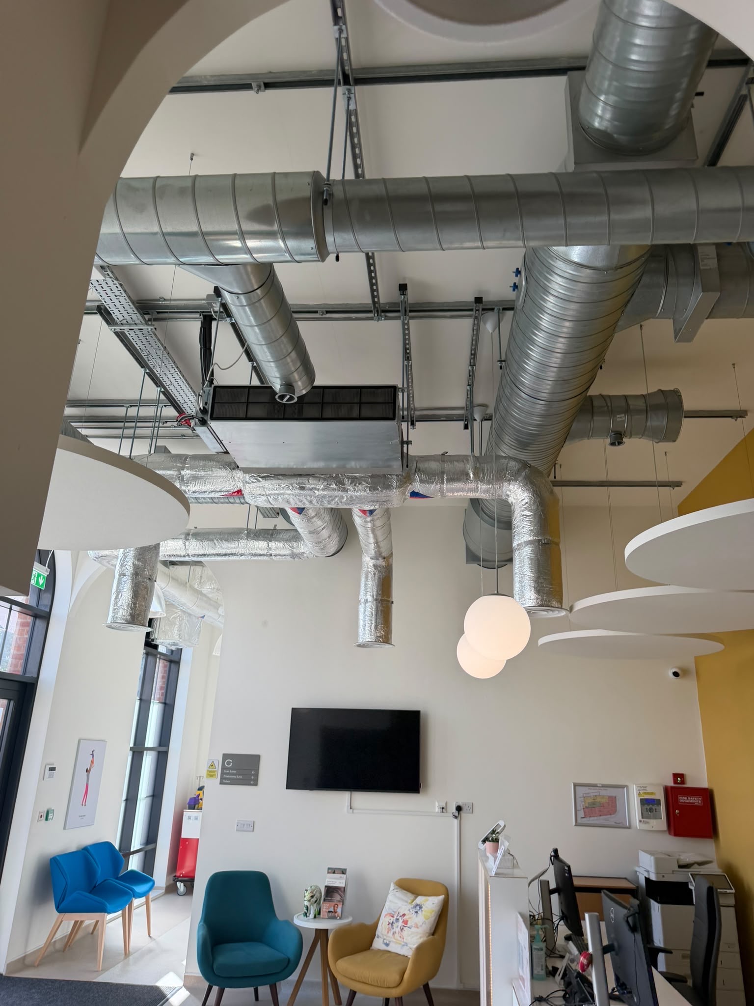 Mitsubishi ducted air-conditioning units coordinated within an exposed-services interior