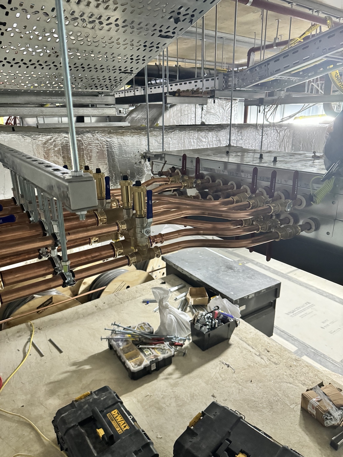 Detailed copper Hybrid VRF pipework supported beneath cable tray