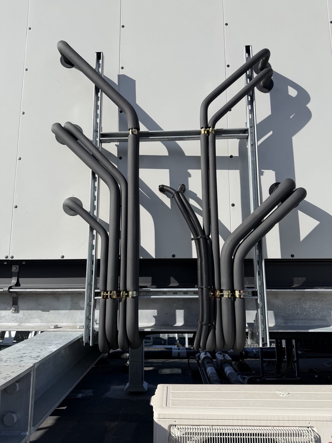 Insulated refrigeration pipework for a multi-stage DX coil installation serving an operating theatre