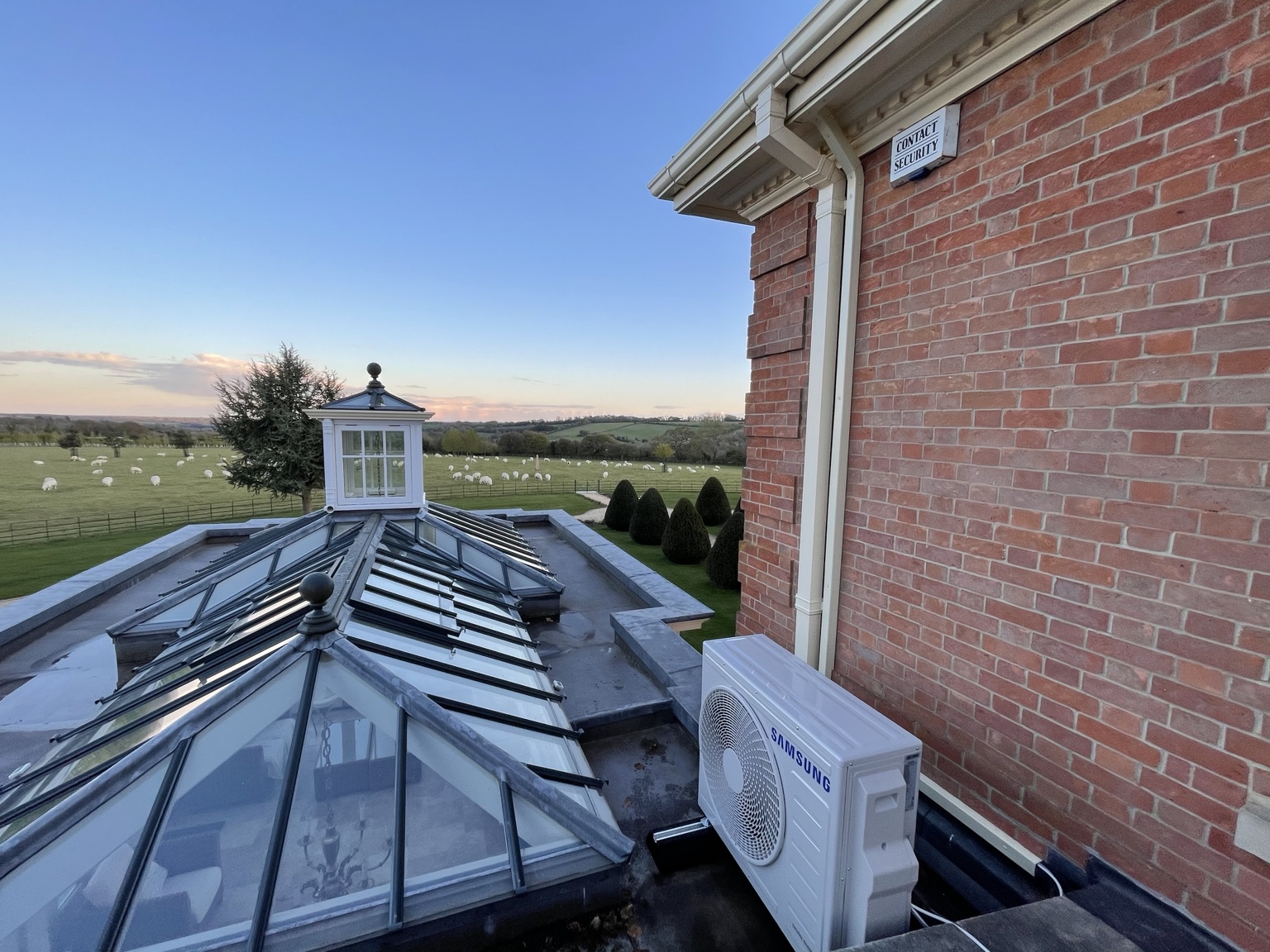 Samsung outdoor air-conditioning unit with purpose-made powder-coated trunking positioned beside the rainwater downpipe