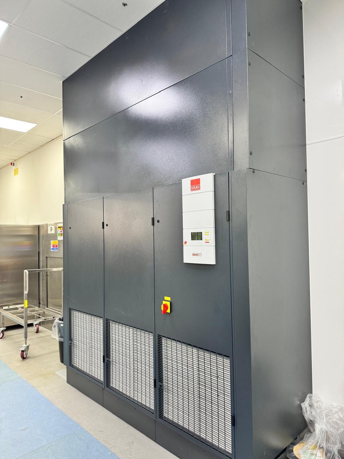 Large STULZ close-control cooling unit positioned within a manufacturing area